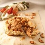A piece of apple pie on a piece of paper.