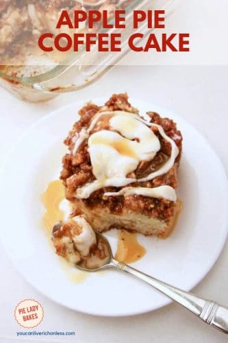 slice of apple pie coffee cake on white plate with spoon, lots of white icings and caramel sauce