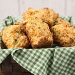 Cheesy biscuits in a basket on a table.