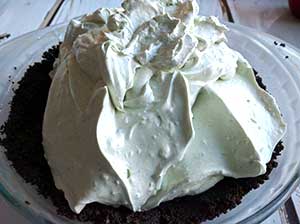 This scrumptiously super EASY no bake grasshopper pie is so light and fluffy – full of delicious Cool Whip, cream cheese, Oreos and Crème de Menthe! With a smooth minty chocolate-y taste, folks will ask for seconds. Think mint chocolate chip ice cream!