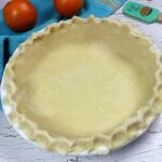 pie crust in white pie plate ready to bake, perfect flaky pie crust