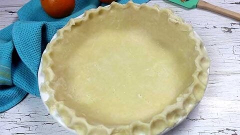 pie crust in white pie plate ready to bake, perfect flaky pie crust