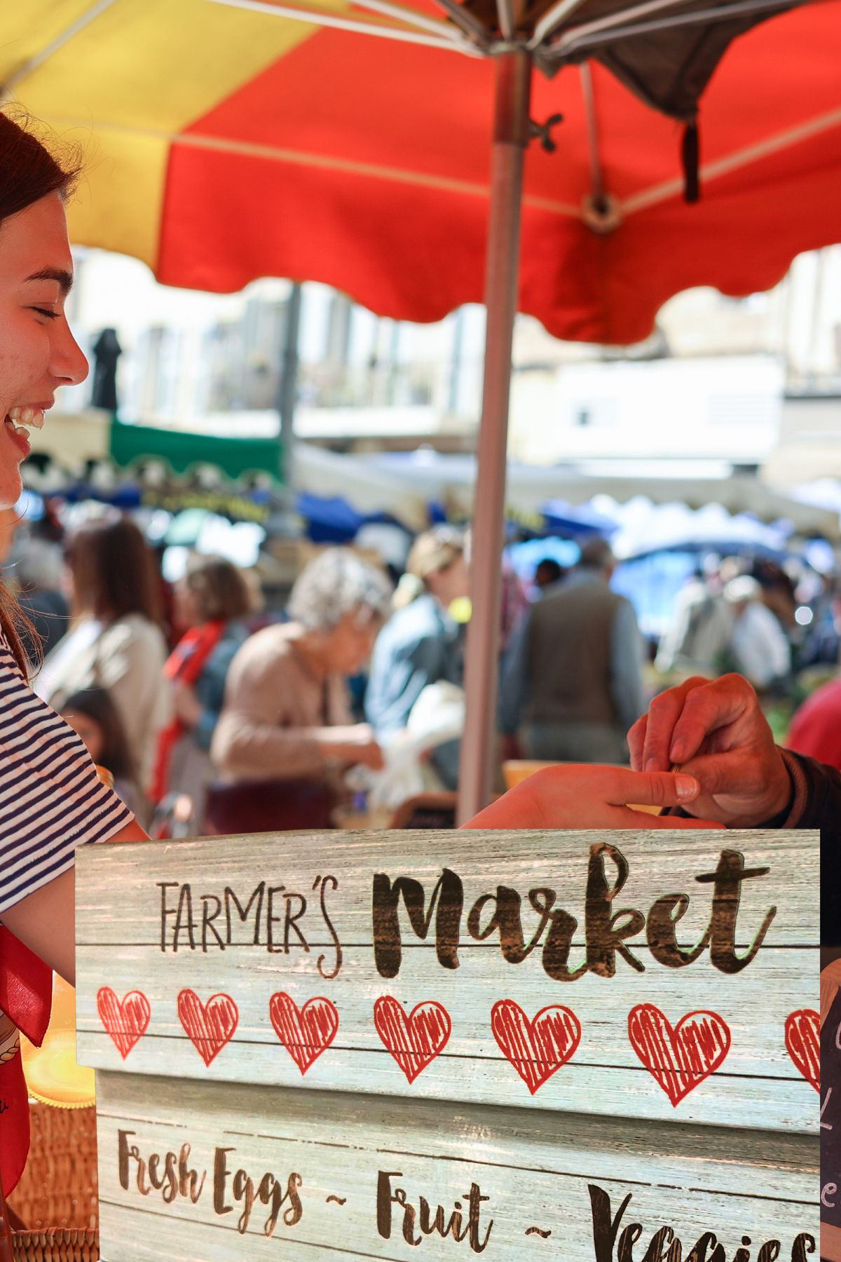 Farmer's market sign and red umbrella