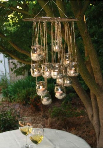 mini glass gloves held up by chains hanging from a tree