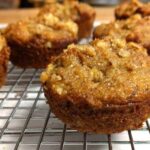 close up of banana walnut muffins on wire baking rack