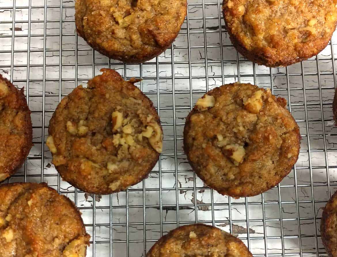 overhead view of several banana muffins on baker's cooling rack