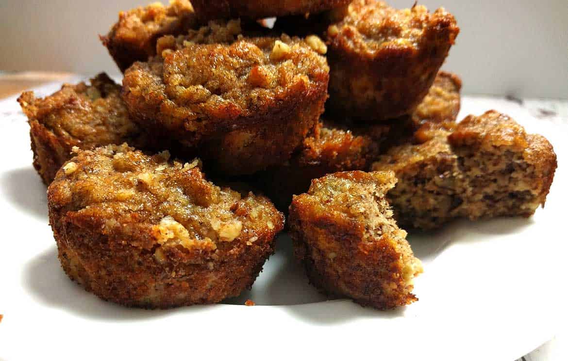 banana muffins piled on a white plate 