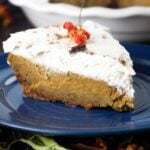 A slice of pumpkin pie on a blue plate.