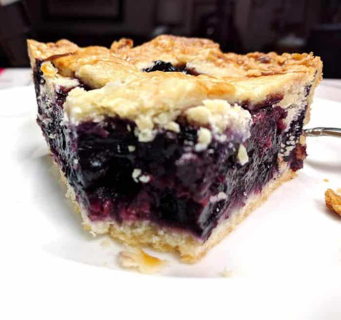 close up razzleberry pie with bite taken out