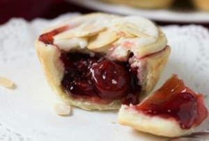 cranberry tart on white plate showing cranberry cherry filling