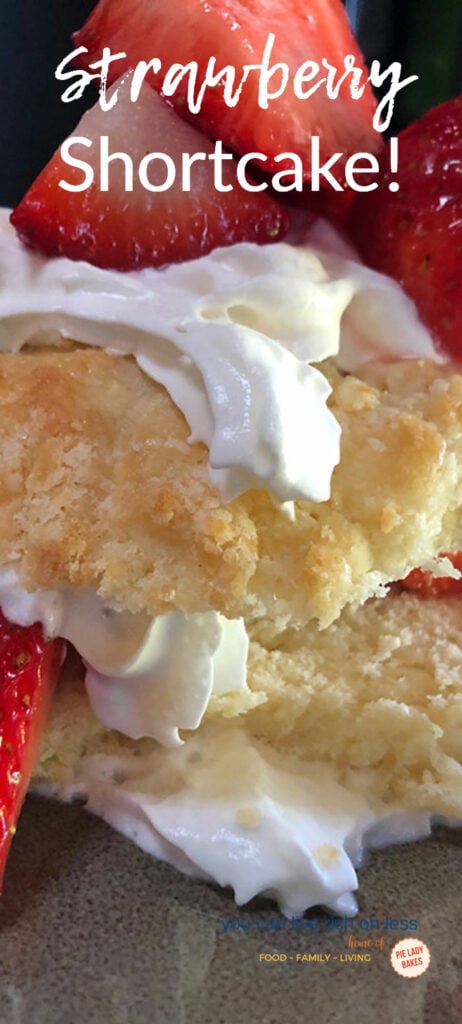 close up view of strawberry shortcake shows biscuits, whipped cream and big juicy red strawberries
