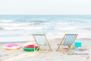 two empty beach chairs, one blue & white stripes, colourful toys in the background