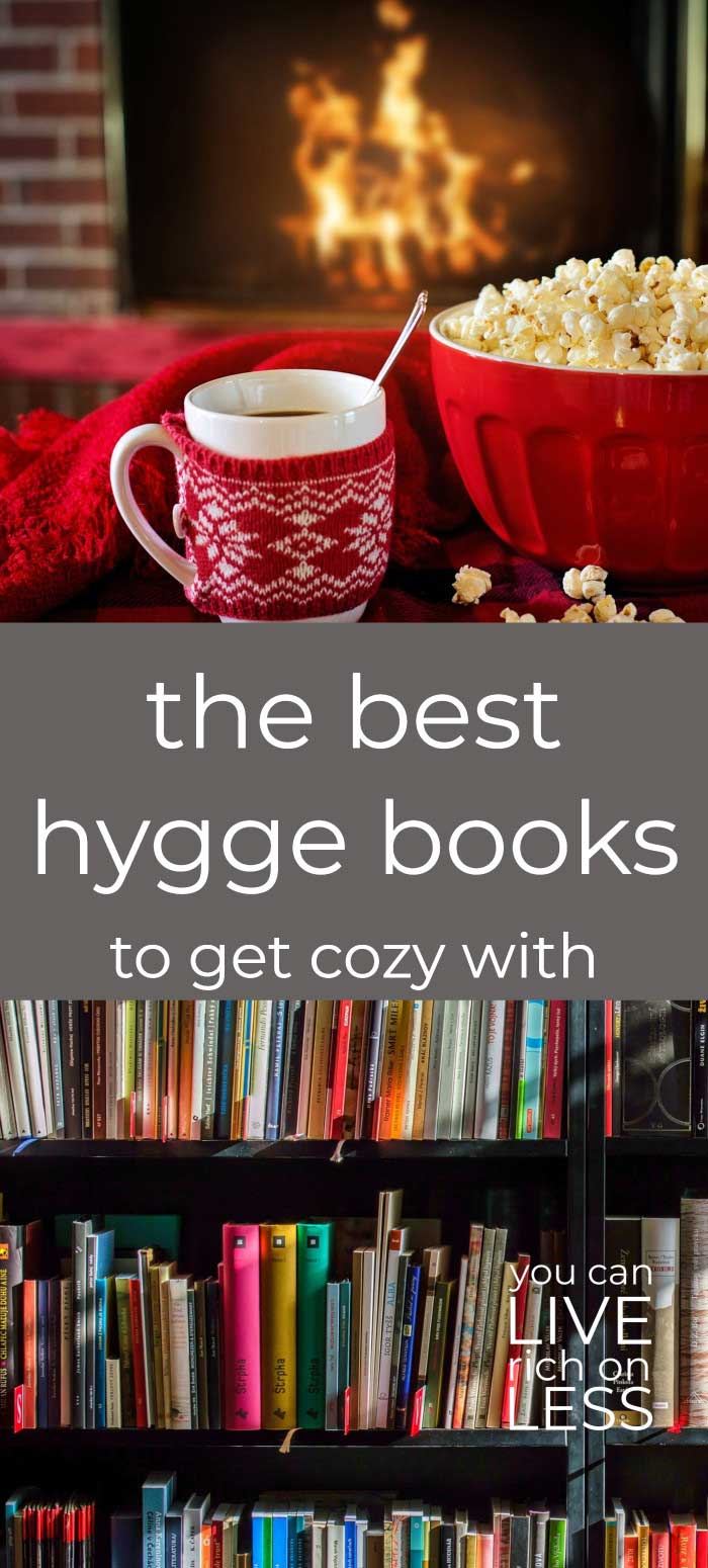 red mug and red bowl of popcorn in front of a fireplace, on top of image showing multi colored books on shelves with text that read the best hygge books to get cozy with