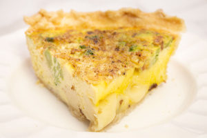broccoli quiche slice on a white plate