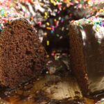 buttermilk chocolate pound cake on glass plate with slice removed
