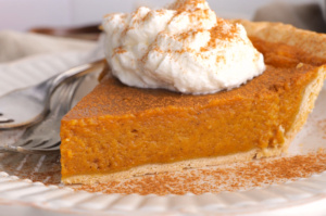 closeup view of pumpkin pie with whipped cream