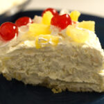 no bake pineapple pie with cool whip side view of slice of pie