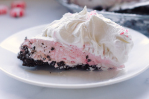 slice of candy cane pie on a white plate