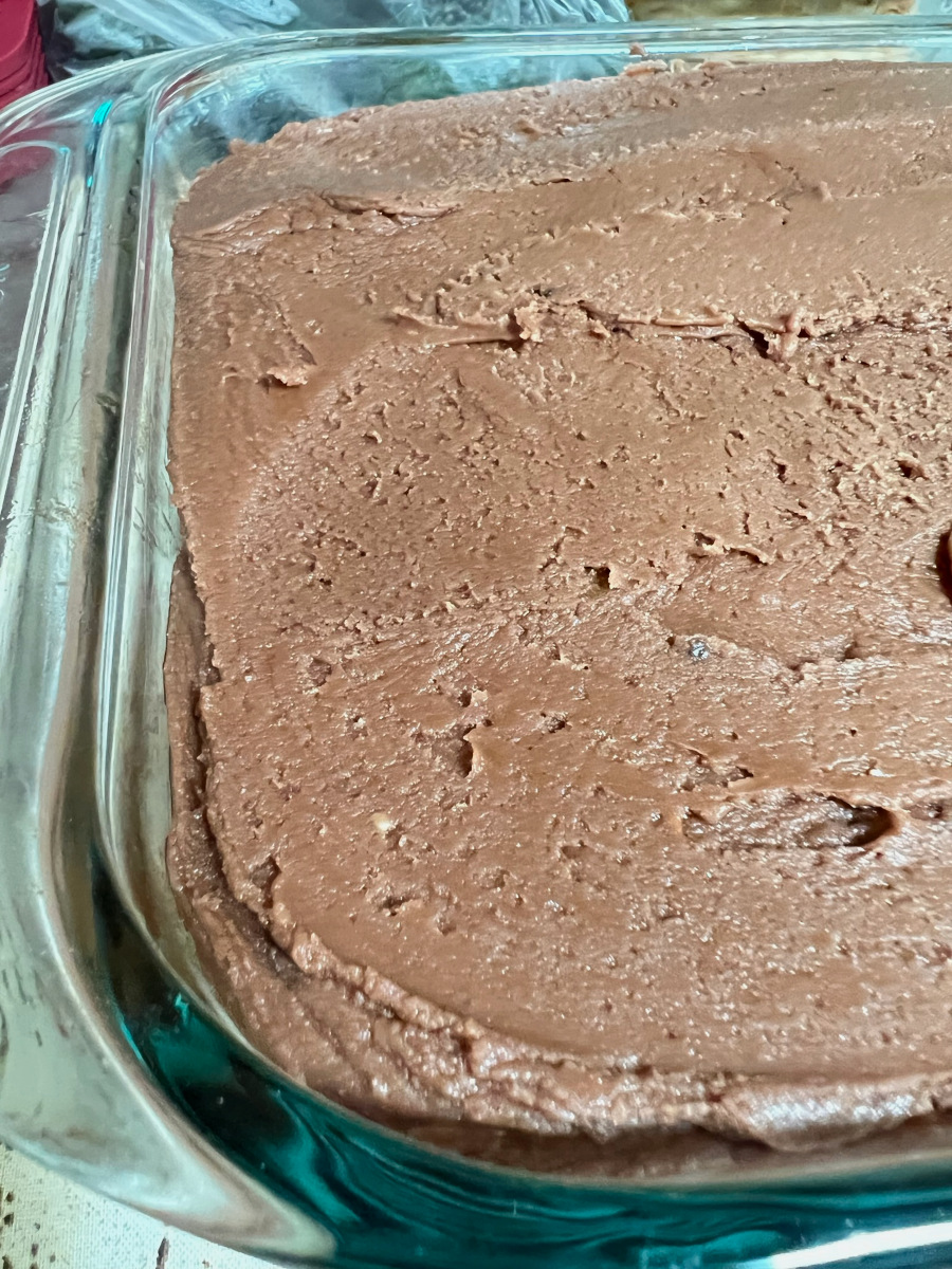 spreading the icing over the top of the cake