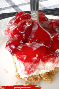 slice of no bake cherry cheesecake and fork