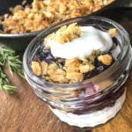 easy blueberry crisp recipe serving in glass jar with yogurt