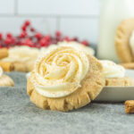 Cinnamon sugar cookies with whipped cream and cinnamon sticks.