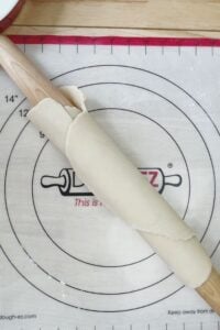 A rolling pin with a dough on top of it.