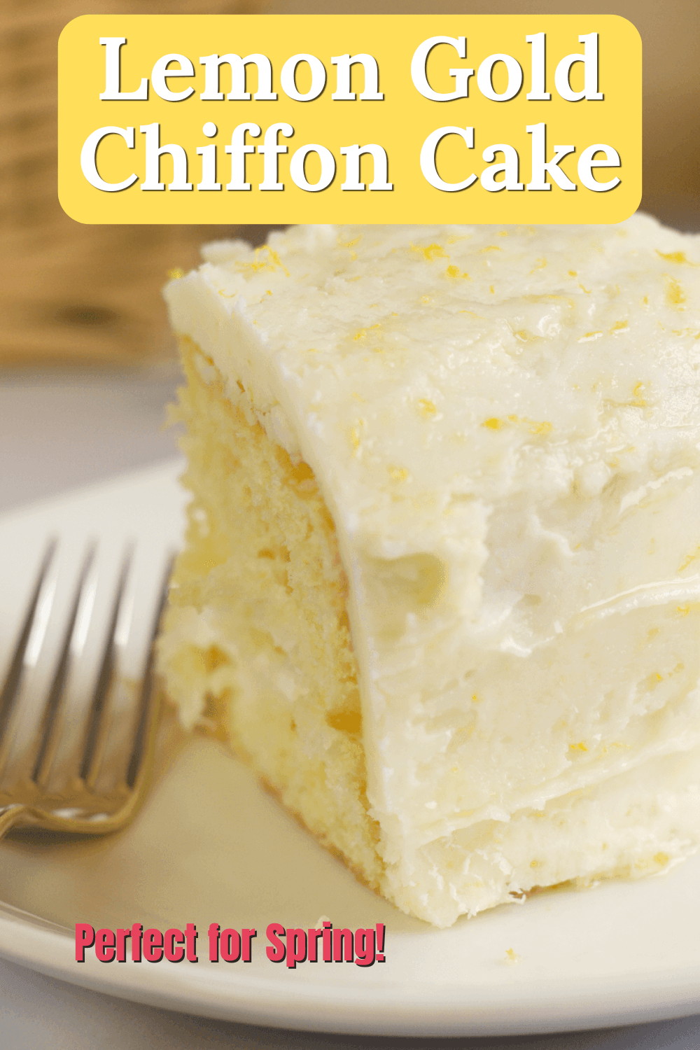 A slice of lemon gold chiffon cake with creamy frosting and lemon zest sits on a white plate next to a fork. Text reads, "Lemon Gold Chiffon Cake" and "Perfect for Spring!.