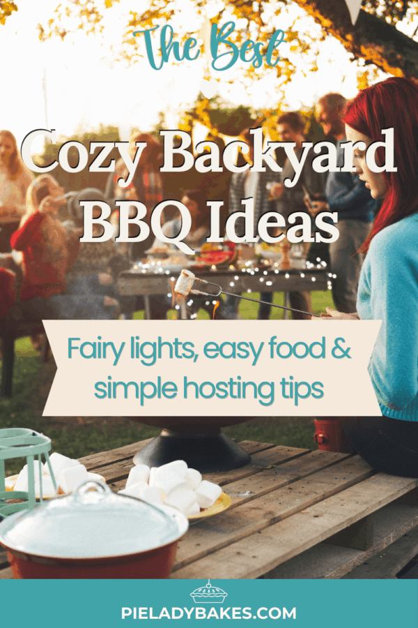 People gathered in a backyard around a table with food, fairy lights hanging above, and marshmallows on sticks by a fire. Text overlay promotes cozy BBQ ideas and hosting tips.